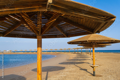 Fototapeta Naklejka Na Ścianę i Meble -  Sunset on the beach with parasol overlooking the Red Sea in Hurghada, Egypt