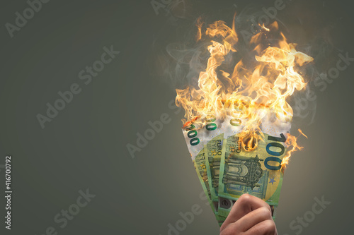 Burning money - 100 Euro banknotes on fire photo