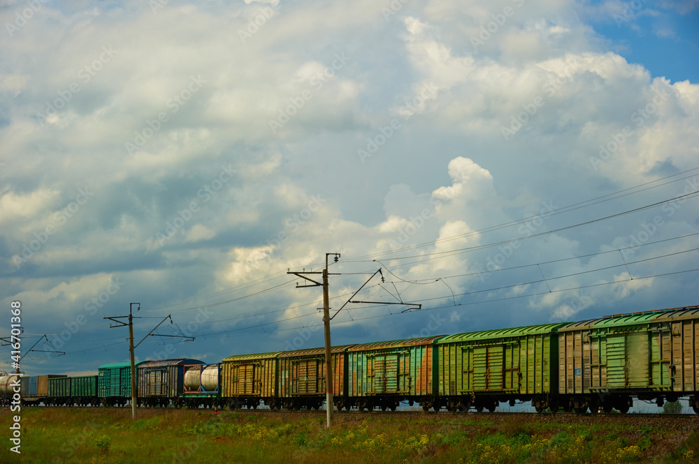 The railway train carries out cargo transportation in the steppe zone of a large country. The railway train carries out cargo transportation in the steppe zone of a large country.