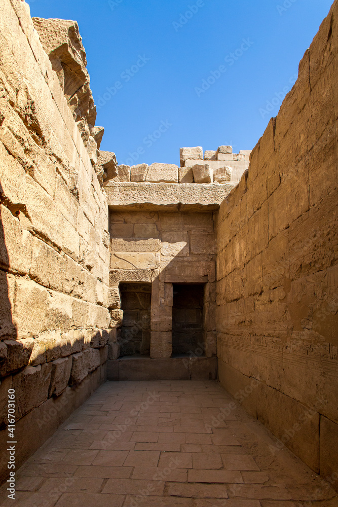 KARNAK TEMPLE - Massive columns inside beautiful Egyptian landmark with hieroglyphics, and ancient symbols. Famous landmark in the world near the Nile River and Luxor, Egypt