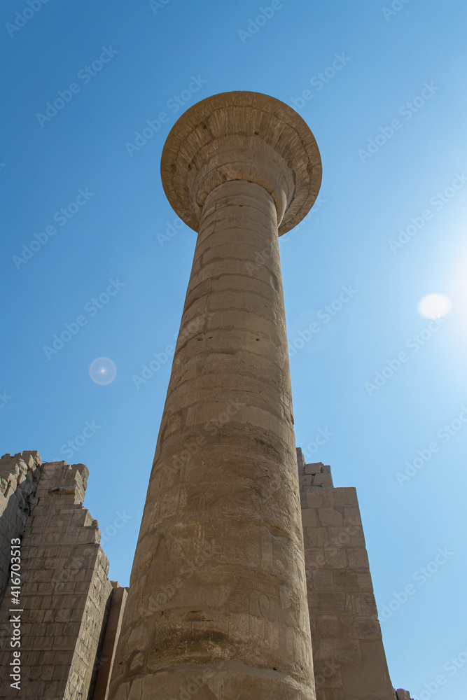 KARNAK TEMPLE - Massive columns inside beautiful Egyptian landmark with hieroglyphics, and ancient symbols. Famous landmark in the world near the Nile River and Luxor, Egypt