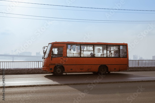 фотографія A red bus with passengers travels along the Kanavinsky Bridge in Nizhny Novgorod