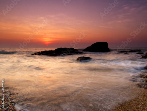 Beautiful natural seascape wave hit the rock during sunrise