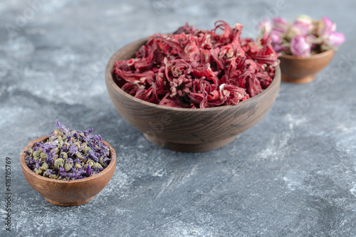 Variety of dried flowers in wooden bowls