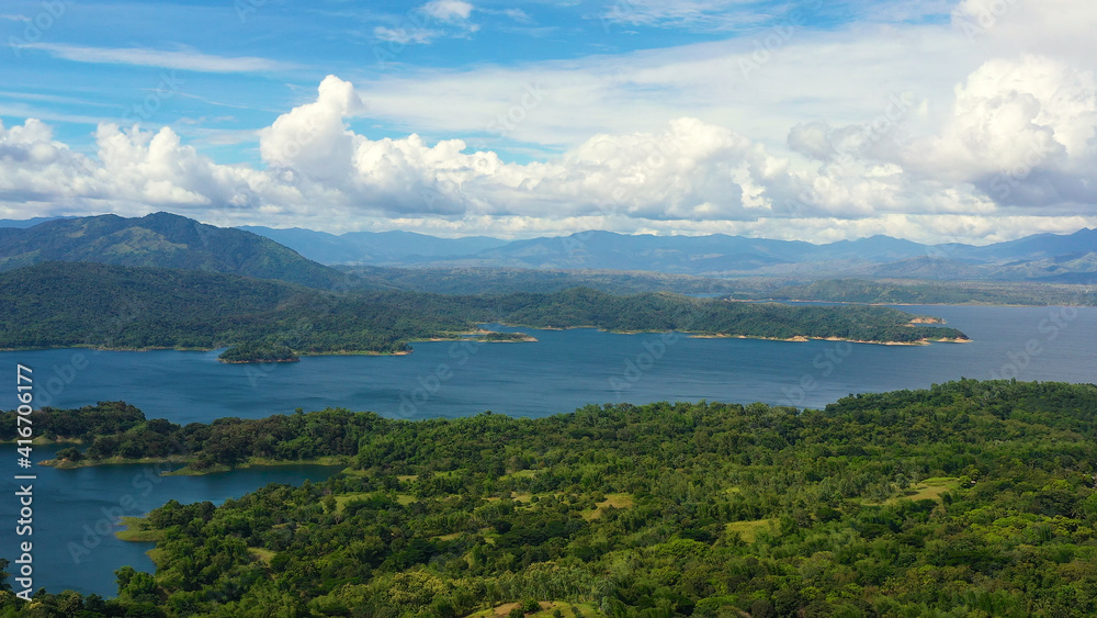Naklejka premium Landscape with beautiful lake against blue sky and clouds.Mountain landscape in the tropics. Pantabangan lake, Philippines, Luzon.