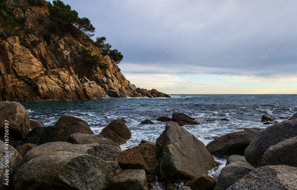 The rocky shore of Tossa de Mar,Costa Brava, Spain, at the foot of the medieval fortress.
