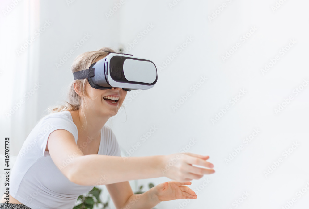 Young happy Caucasian woman enjoy using virtual reality goggles or headset device. futuristic and cyberspace experience at home. Modern lifestyle of technology and innovation leisure activity Young happy Caucasian woman enjoy using virtual reality goggles or headset device. futuristic and cyberspace experience at home. Modern lifestyle of technology and innovation leisure activity