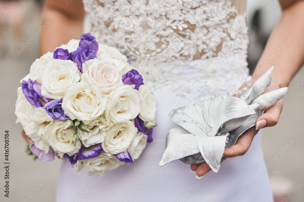 The bride holds a bouquet of flowers in her hands. Bridal bouquet. Without face The bride holds a bouquet of flowers in her hands. Bridal bouquet. Without face