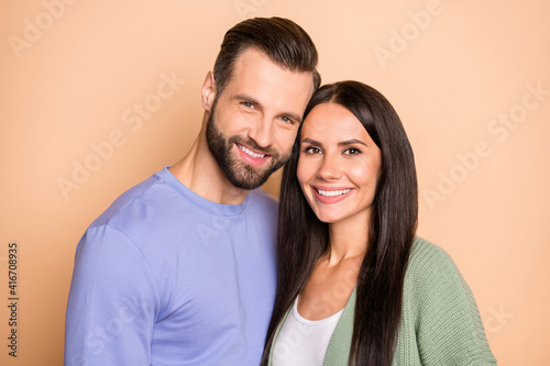 Photo of optimistic brunette nice couple wear sweater isolated on beige color background