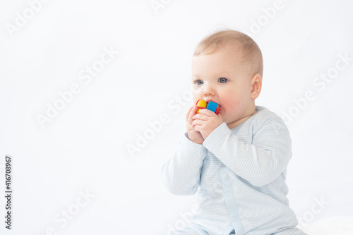Pretty baby/infant plays with a toy