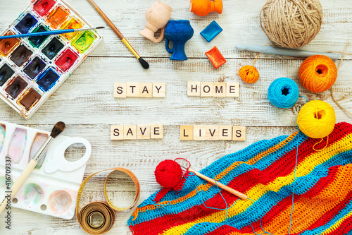Wooden letters form the expression "stay home, stay safe."