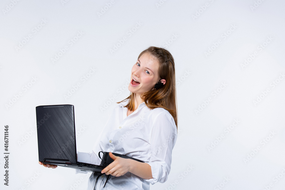 Caucasian blonde woman smiling, holding laptop computer, looking to camera, excited for success on light gray background. Young and confident businesswoman working online, stream blogger Caucasian blonde woman smiling, holding laptop computer, looking to camera, excited for success on light gray background. Young and confident businesswoman working online, stream blogger