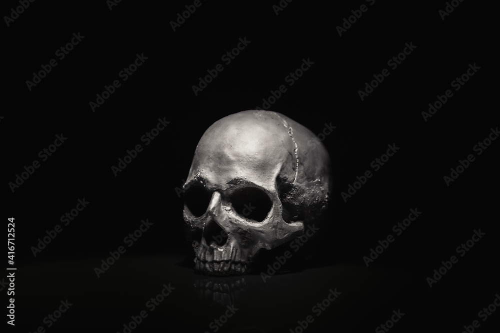Spooky dark black skull aginast dark background Spooky dark black skull aginast dark background