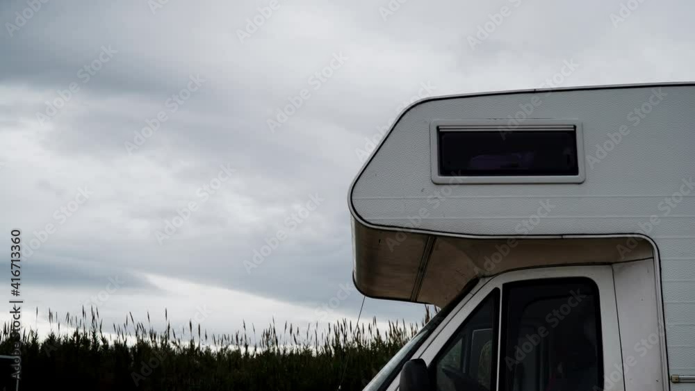 Camper vehicle on coast nature and clouds moving across overcast sky. Time lapse. Caravan vacation in Spain Camper vehicle on coast nature and clouds moving across overcast sky. Time lapse. Caravan vacation in Spain