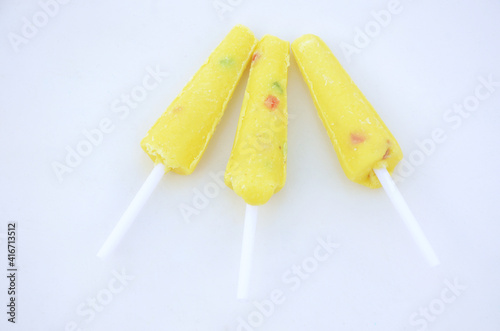 the sweet yellow cream lollypop isolated on white background.