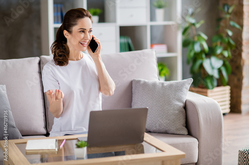 Photo of young happy positive good mood businesswoman working remotely speaking on phone at home house