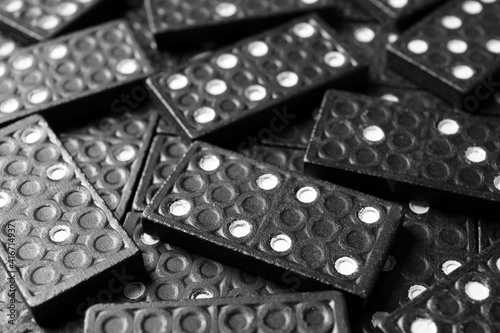Set of black domino tiles as background, closeup