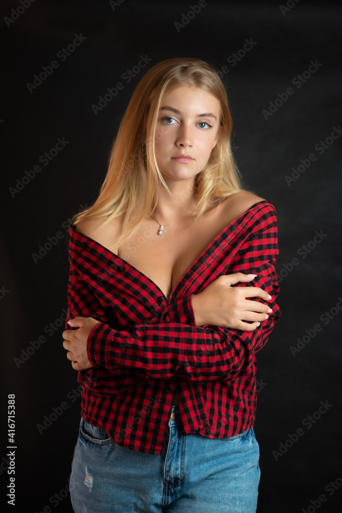 Portrait of beautiful woman with blue eyes in black-red shirt. Portrait of beautiful woman with blue eyes in black-red shirt.