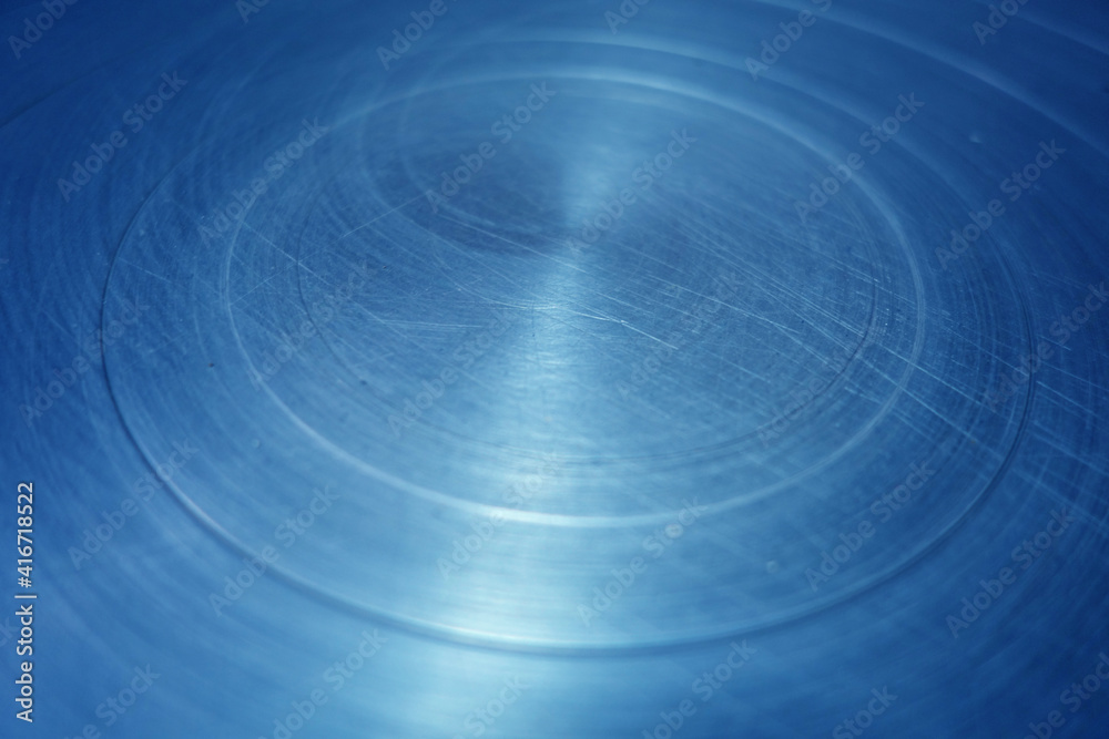 Fototapeta premium Scratched blue toned round metal surface