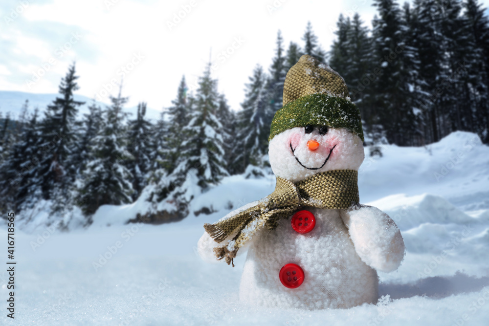 Cute small decorative snowman outdoors on sunny day, space for text