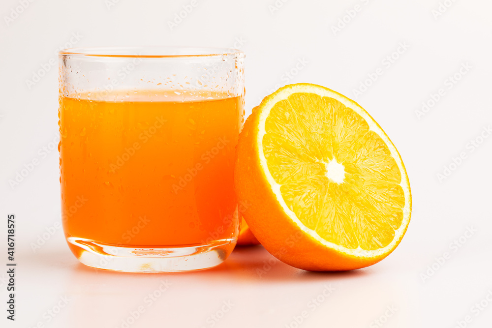 An orange in fruit with full and a half showing in isolated background. An orange in fruit with full and a half showing in isolated background.
