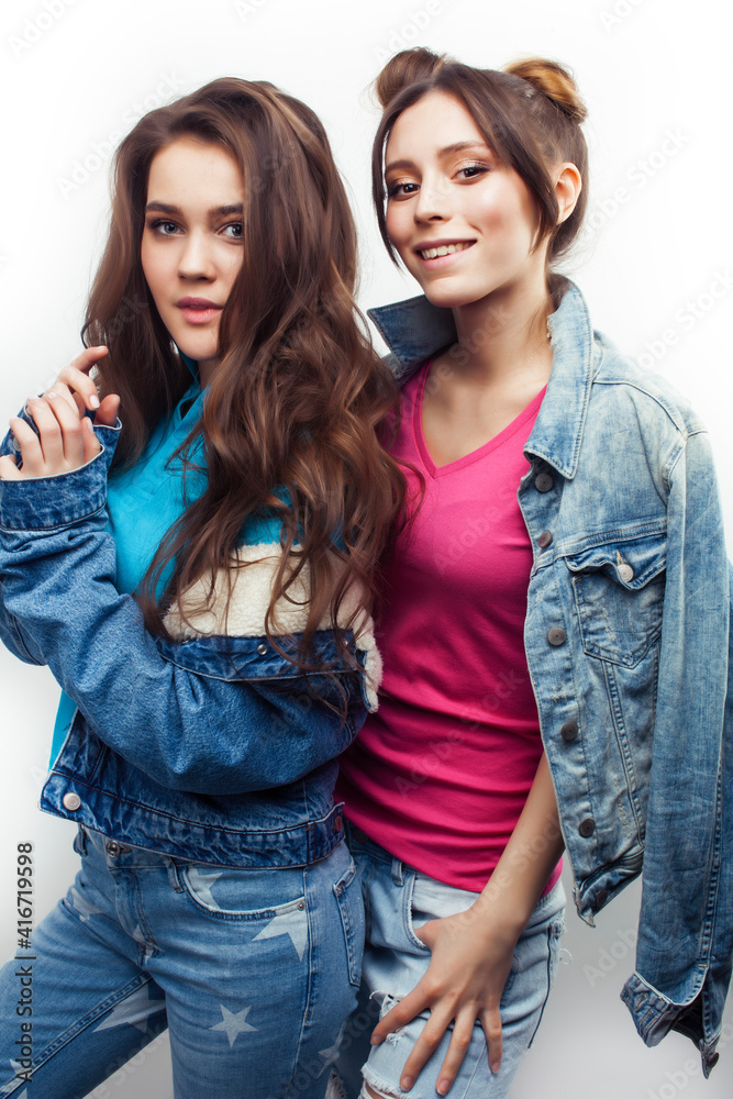 lifestyle and people concept: Fashion portrait of two stylish sexy girls best friends, over white background. Happy time for fun lifestyle and people concept: Fashion portrait of two stylish sexy girls best friends, over white background. Happy time for fun