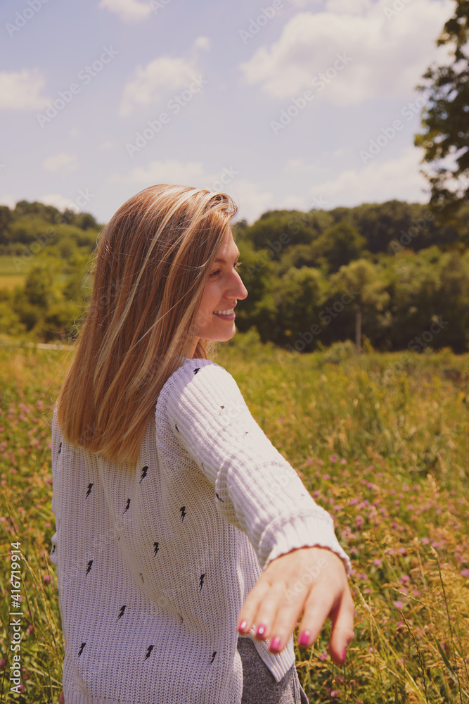 Young woman standing and enjoying the view of nature.
