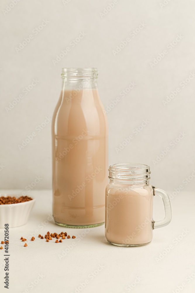 Non dairy buckwheat milk in glass bottle and jar Non dairy buckwheat milk in glass bottle and jar