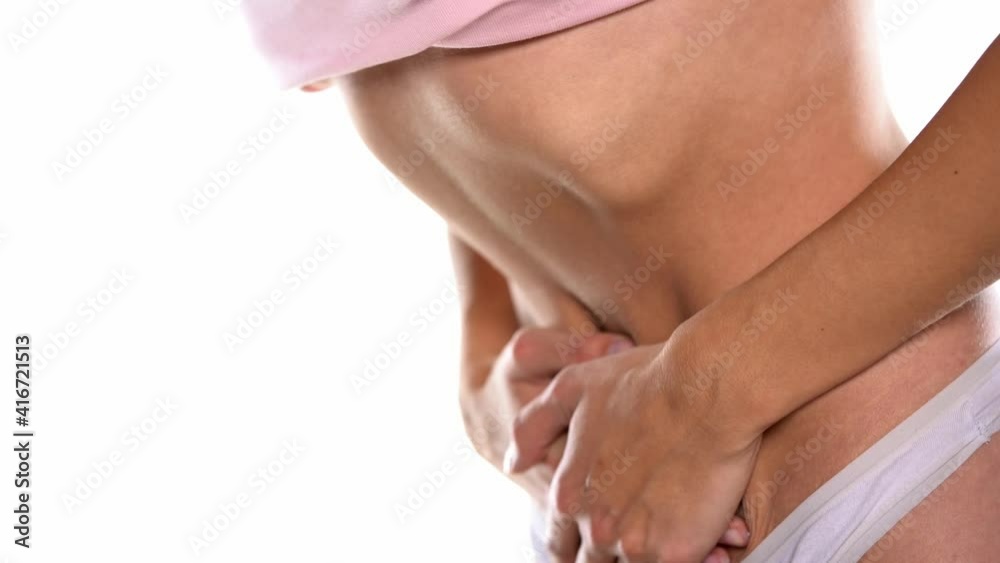 stomach cramps. a woman holding her stomach on a white background stomach cramps. a woman holding her stomach on a white background
