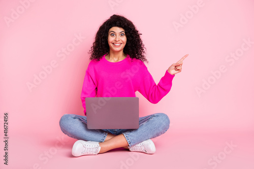 Full size photo of young happy crazy excited girl working in laptop point finger copyspace isolated on pink color background