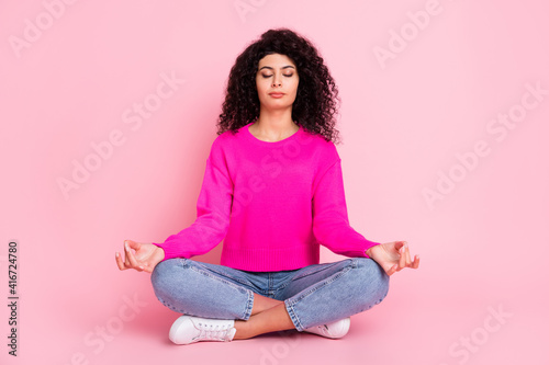 Full size photo of young lovely pretty charming girl sit floor meditating crossed legs isolated on pink color background
