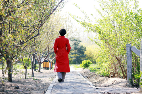 A lady in red takes a walk in the park, North China