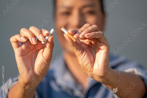 Beauty woman happy to breaking a cigarette. Wold tobacco day and  quit smoking cigarettes concept