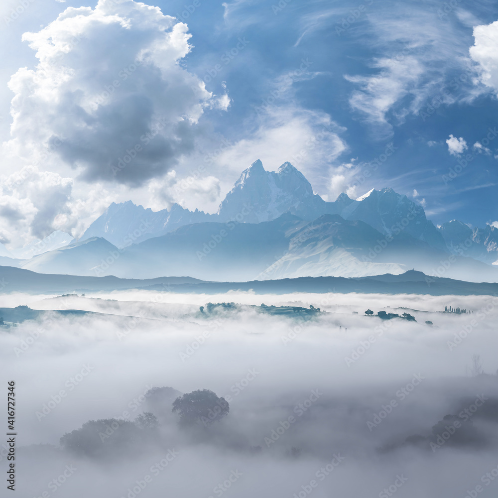 Landscape with mountains and fog in valley
