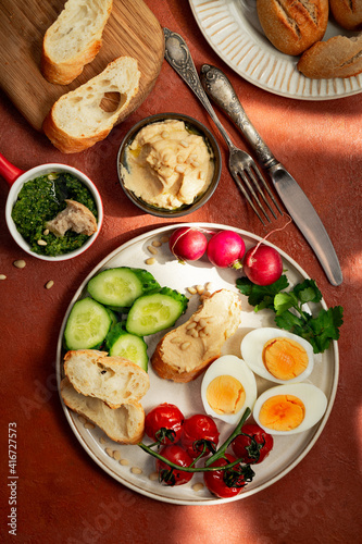 Mediterranean style breakfast plate on terracotta background