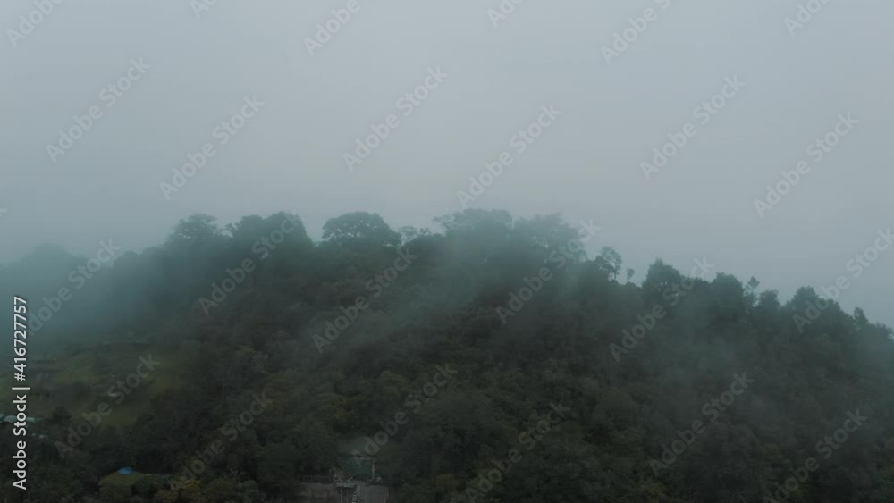 Drone aerial flying towards misty cloud forest on the summit of green mountain in Guatemala Drone aerial flying towards misty cloud forest on the summit of green mountain in Guatemala