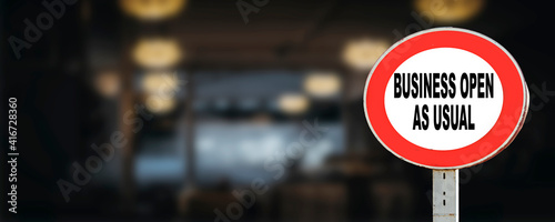 Business open as usual. circle sign stating business open as usual in front of restaurant or shop. Business open as usual sign during coronavirus covid-19 pandemic