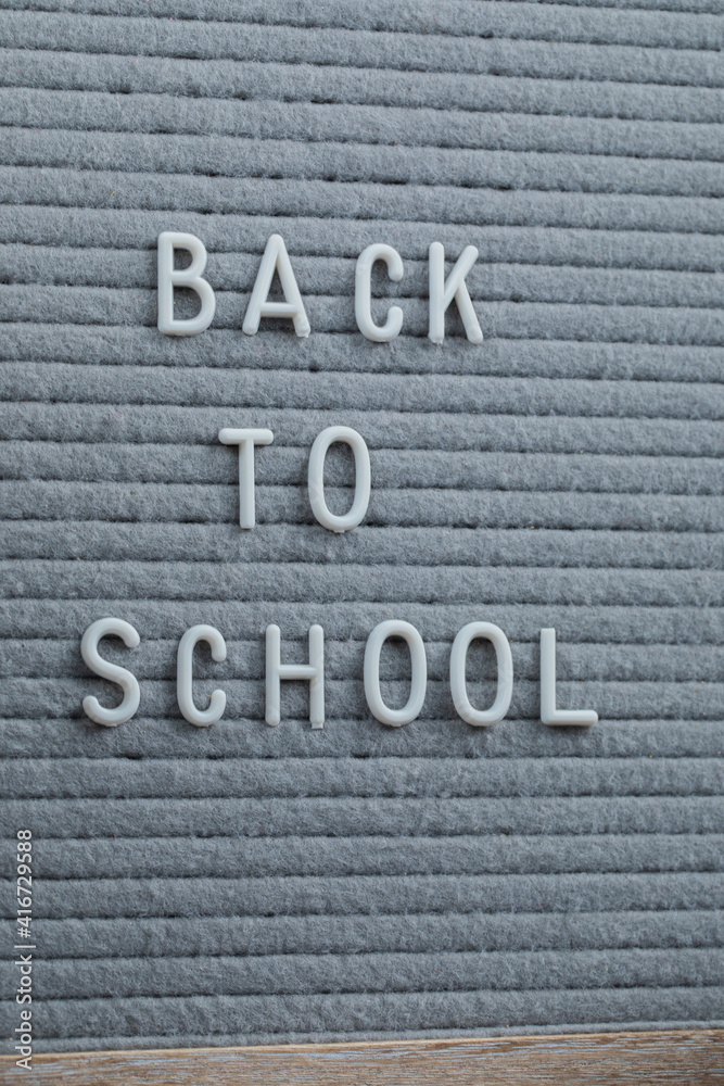 Fototapeta premium Back to school phrase embedded on grey background