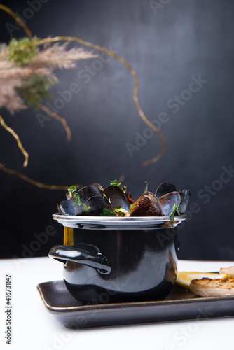 Photo of tasty delicious fresh mussels boiled in a pan  sea food.