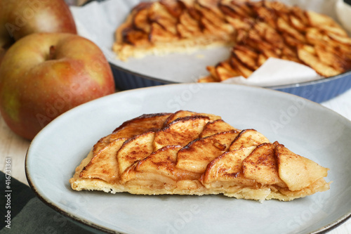 Tableau sur toile A slice of traditional classic French fine apple tart in a plate made with puff