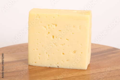 Ein großes Stück Käse auf einem Holzbrett