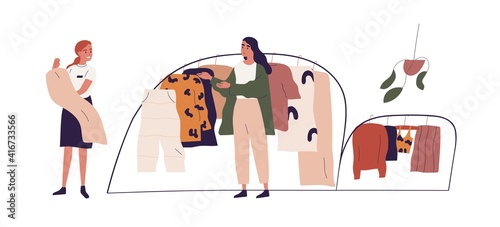 Young woman choosing fashion apparel with help of shop assistant in clothing store. Seller and buyer in showroom. Colored flat vector illustration of saleswoman and customer isolated on white