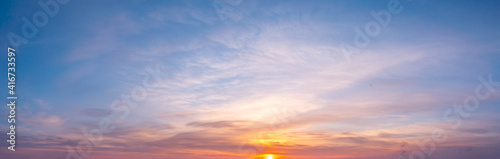 panoramic sunrise with cirrus clouds illuminated by the rays of the sun © yelantsevv