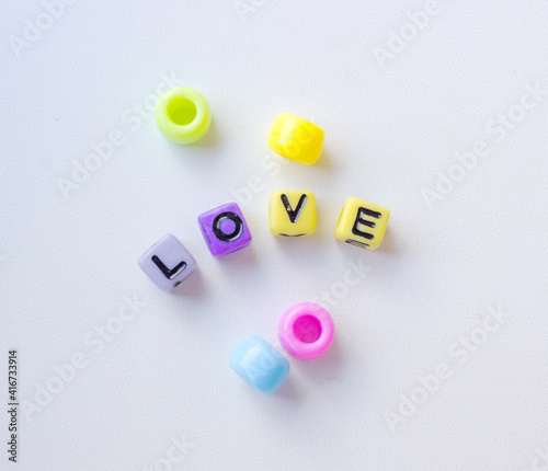the inscription love made of colorful beads