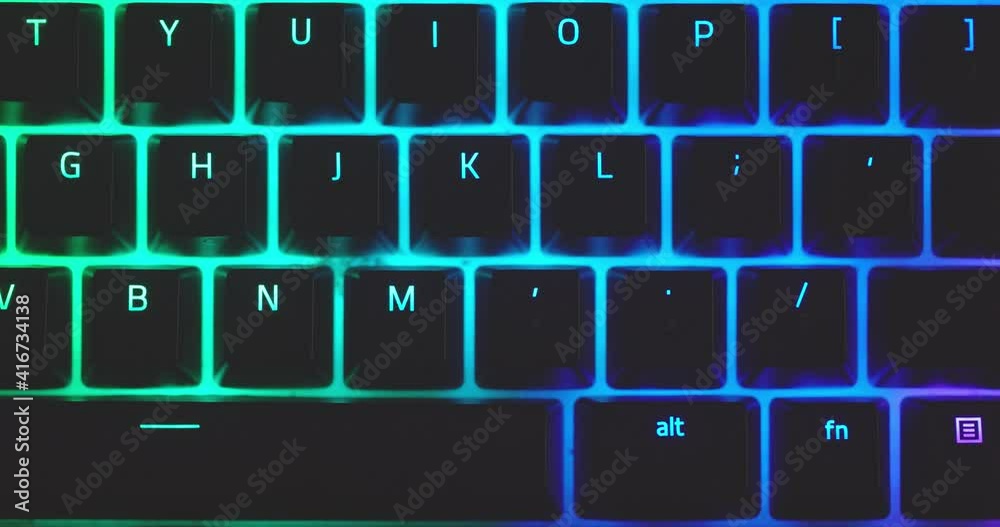 Closeup of illuminated mechanical keyboard keys in motion
