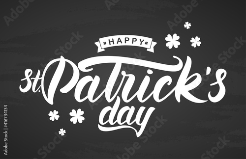 Hand brush lettering of Happy St. Patrick's Day on chalkboard background. Typography design.