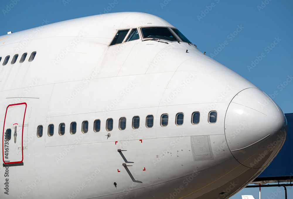 large view of the nose of an airplane at the airport