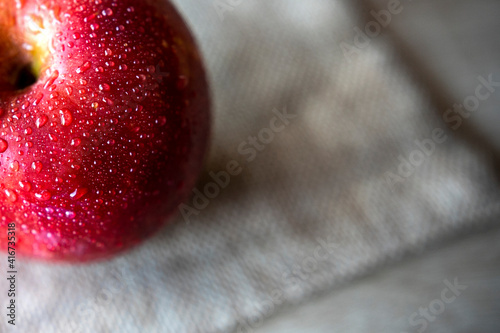 Photograph of two red apples on wooden table. Still life of food. 16: 9 photography. Freshness concept. Space for text.