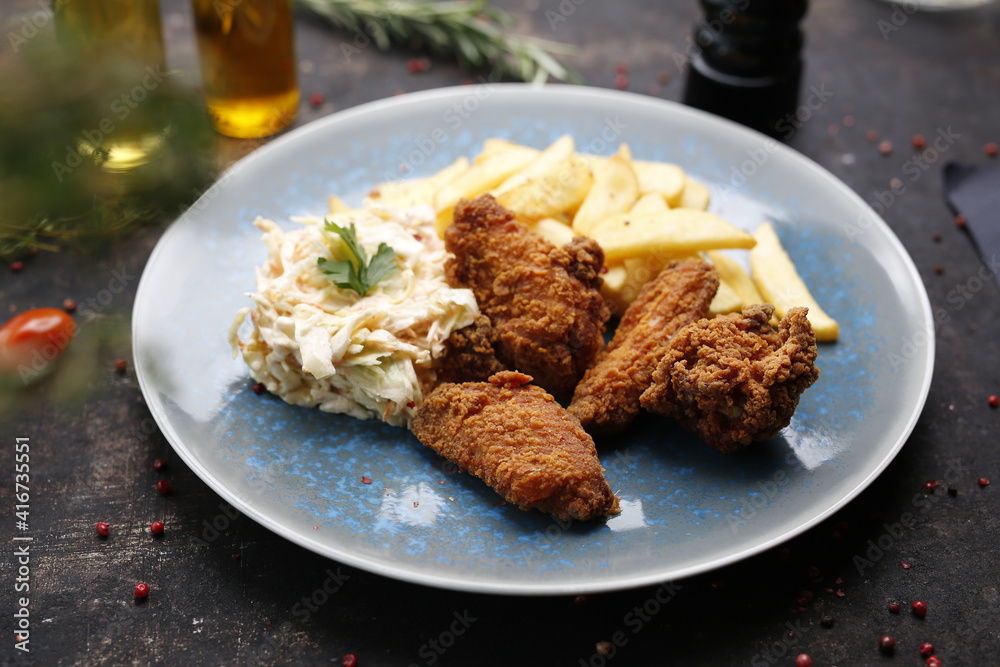 Chicken nuggets with fries and coleslaw. Fast food dinner.
The finished dish served on a plate. Serving proposal, culinary photography.