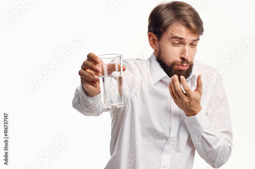 man in white shirt with glass of water in hand promotion cropped view
